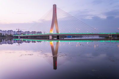 View of bridge over river against cloudy sky