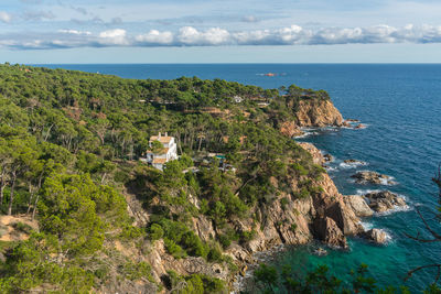 High angle view of townscape by sea against sky