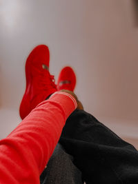 Low section of person wearing red shoes