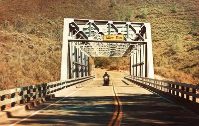 Rear view of man on footbridge