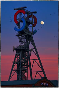 Low angle view of tower against sky during sunset