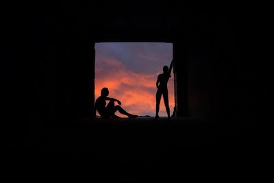 Silhouette couple against sky during sunset