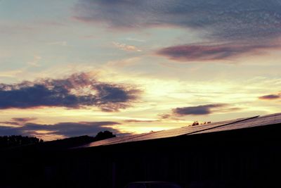 High section of houses against sky at sunset