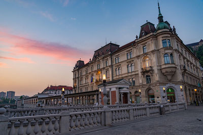 Buildings in city at sunset