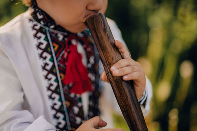 Midsection of woman holding violin