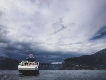 Ship sailing in sea against sky