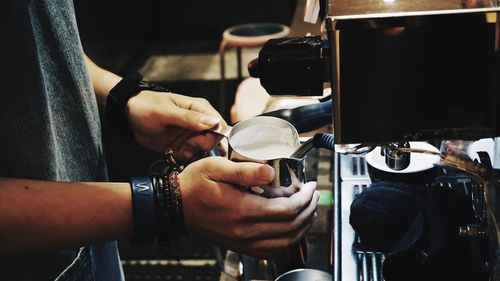 Close-up of man preparing food in cafe