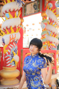 Midsection of woman standing in traditional clothing