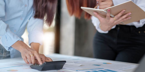 Midsection of woman working on table