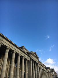 Low angle view of government building against blue sky