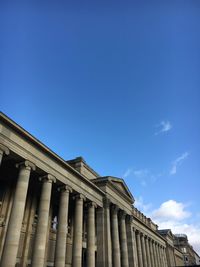 Low angle view of historical building against blue sky