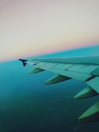 Airplane wing against sky