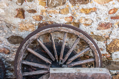 Old rusty wheel on wall