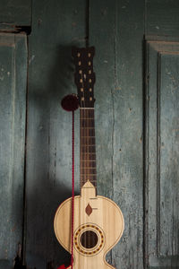 Close-up of guitar against wall