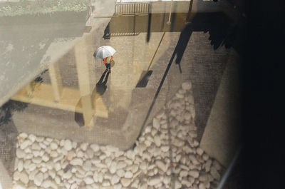 Rear view of woman walking by water