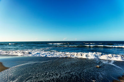 Scenic view of sea against clear blue sky