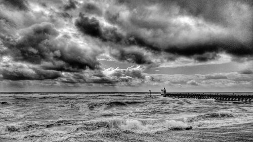 Scenic view of sea against storm clouds