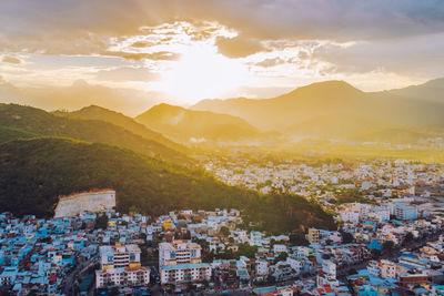 Aerial view of townscape against sky during sunset