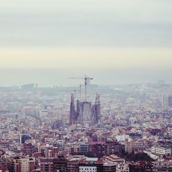 High angle view of incomplete sagrada famalia in city against sky
