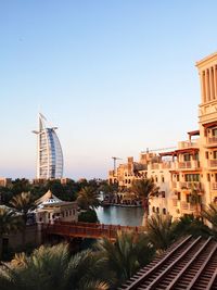 View of buildings against clear blue sky