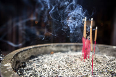 Close-up of burning candles in temple