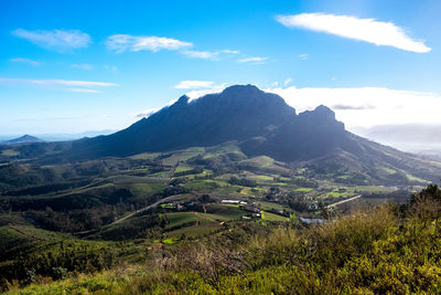 Hiking on slope of mountain overlooking vineyards of stellenbosh 