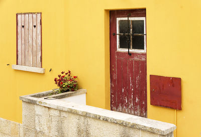 Close-up of yellow wall with closed window