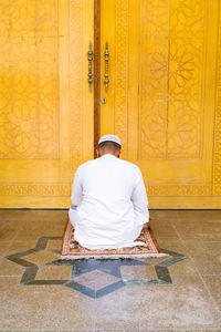 Arabic man praying outside the mosque