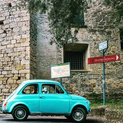 Vintage car against brick wall