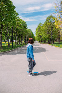 Portrait of boy walking on road