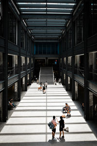 Rear view of man walking on staircase