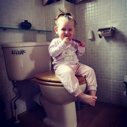 Toddler girl in bathroom