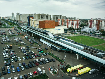 High angle view of vehicles at parking lot in city