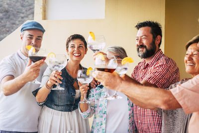 Happy family toasting drinks at home