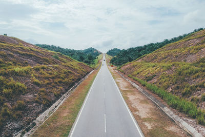 Road amidst mountains against sky