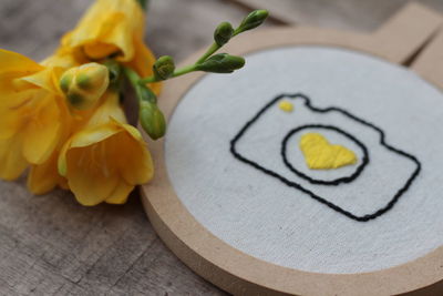 Close-up of yellow flowers on table