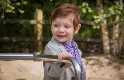 Portrait of smiling boy standing outdoors