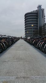 Cobblestone street in city against sky