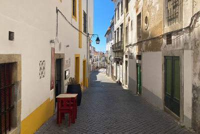 Empty alley amidst buildings in city