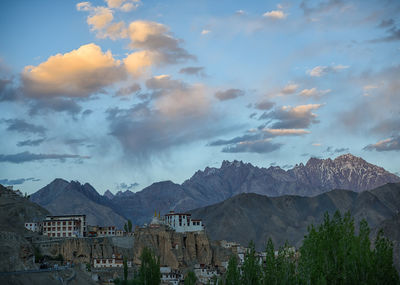 Panoramic view of buildings and mountains against sky