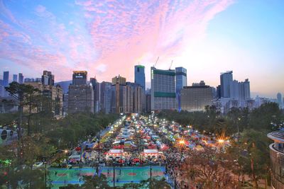 Panoramic view of city buildings against sky during sunset