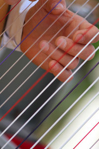 Cropped hand holding colorful strings