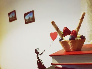 Various fruits on table against wall