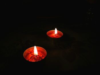 Close-up of illuminated lamp over black background