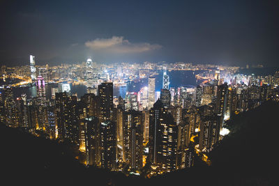 Illuminated cityscape against sky at night