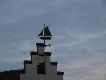 Low angle view of built structure against cloudy sky