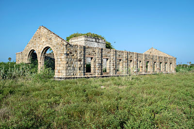 Remains of old heritage stone structure of abandoned steam locomotive shed in mandapam, india.