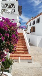 Low angle view of staircase by building against sky