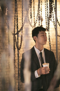 Young man drinking water from coffee