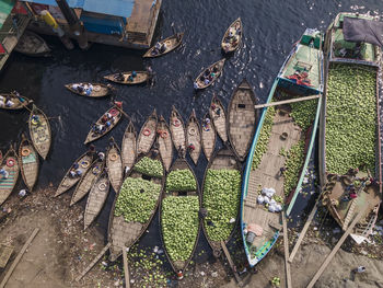 People unloading watermelons at old dhaka river port along buriganga river in dhaka, bangladesh.